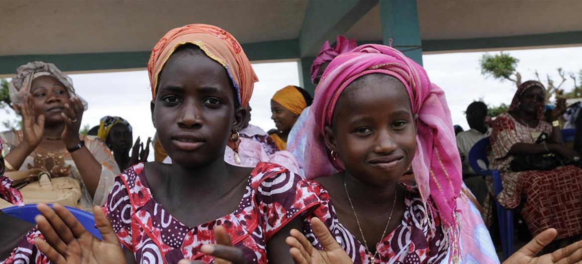 Two girls in Senegal applaud during a celebration of the abandonment of female genital mutilation by several villages in the area